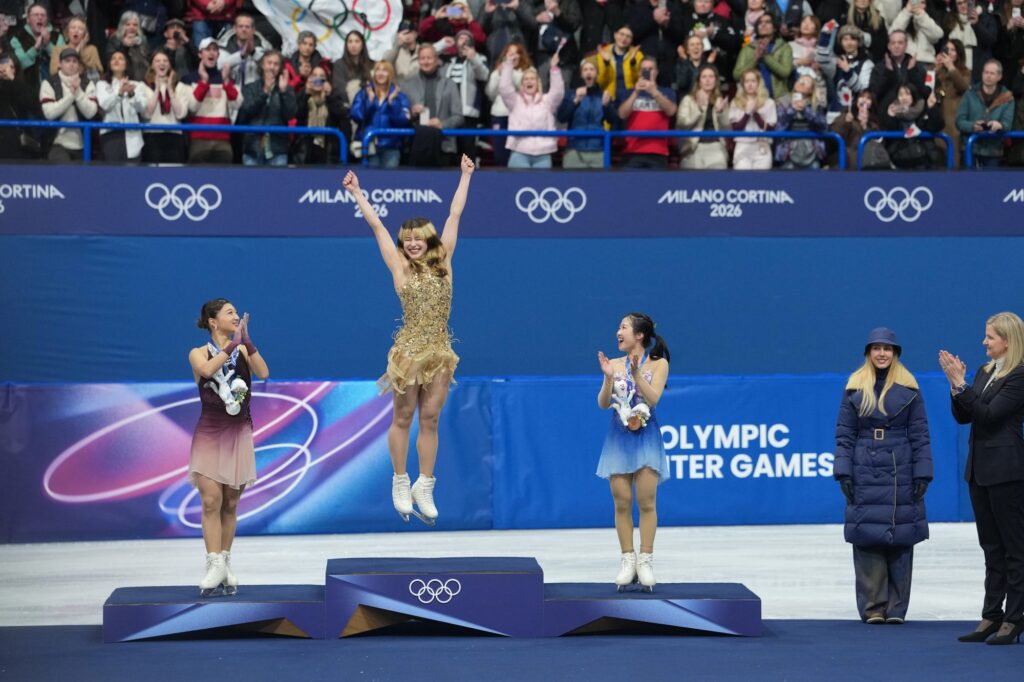 Gold medalist Alysa Liu of the United States, silver medalist Kaori Sakamoto of Japan, and bronze medalist Ami Nakai of Japan, celebrate on the podium during the medal ceremony on Thursday. James Lang/Imagn Images/Reuters